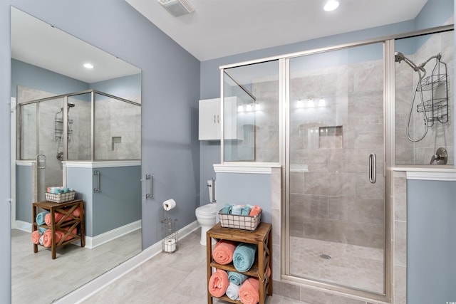 bathroom with toilet and a shower with door