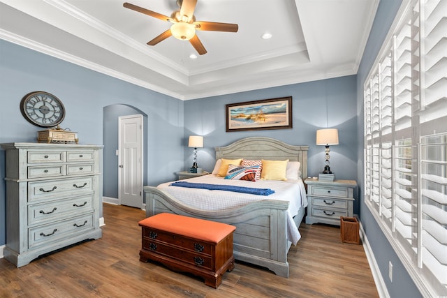 bedroom with ceiling fan, dark hardwood / wood-style flooring, and crown molding