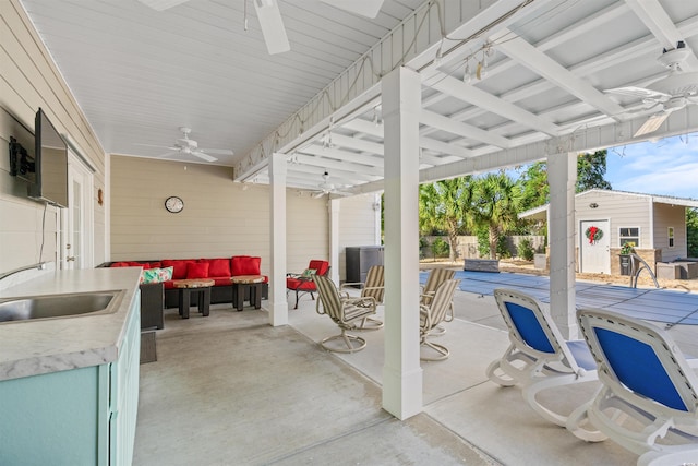 view of patio with ceiling fan, an outdoor living space, sink, and a swimming pool