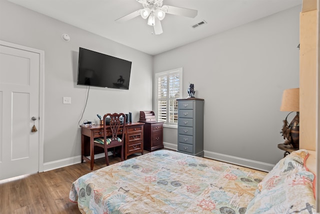 bedroom with ceiling fan and dark hardwood / wood-style flooring