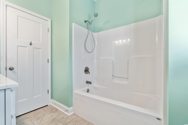 bathroom featuring tile patterned floors and bathing tub / shower combination