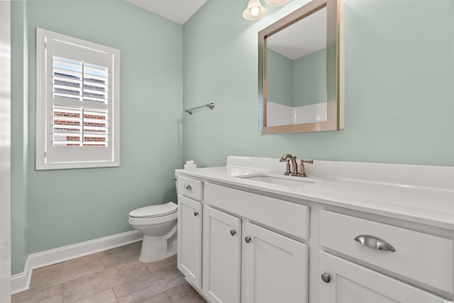 bathroom with tile patterned flooring, vanity, and toilet