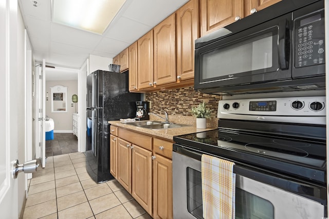 kitchen with tasteful backsplash, stainless steel electric range oven, sink, and light tile patterned flooring