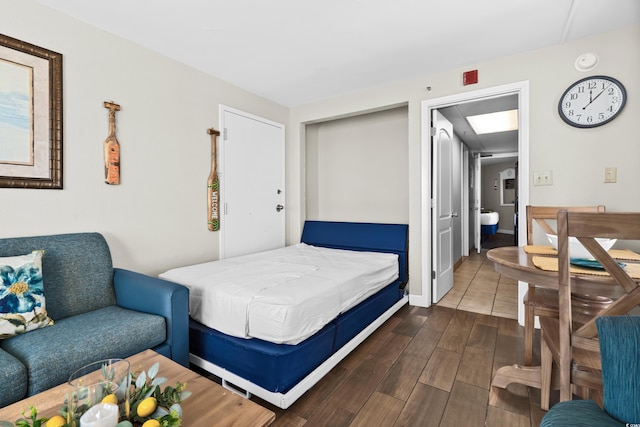 bedroom with dark wood-type flooring