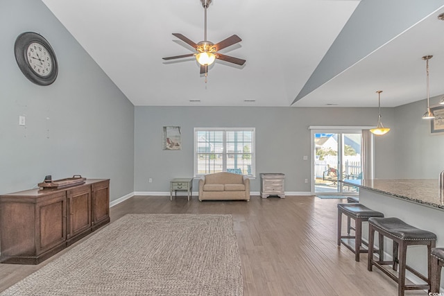 sitting room with lofted ceiling, light hardwood / wood-style flooring, ceiling fan, and a healthy amount of sunlight