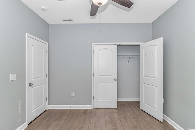 unfurnished bedroom featuring ceiling fan, a closet, and light hardwood / wood-style floors