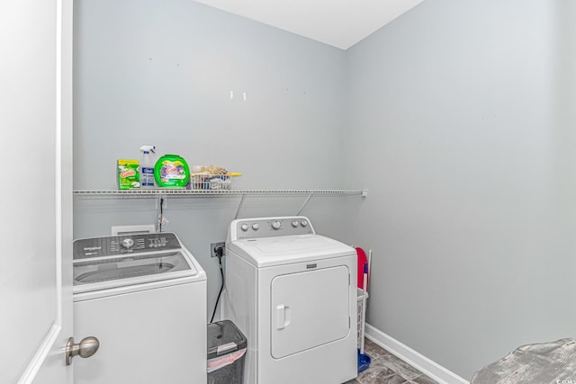 clothes washing area with washing machine and dryer