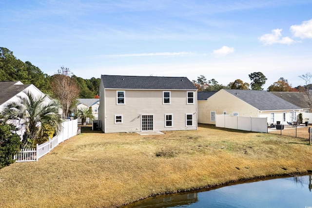 rear view of house with a yard