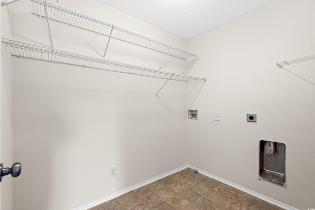 washroom featuring hookup for a washing machine, a textured ceiling, and hookup for an electric dryer