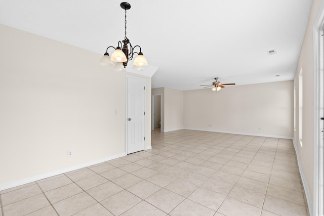 tiled spare room with ceiling fan with notable chandelier