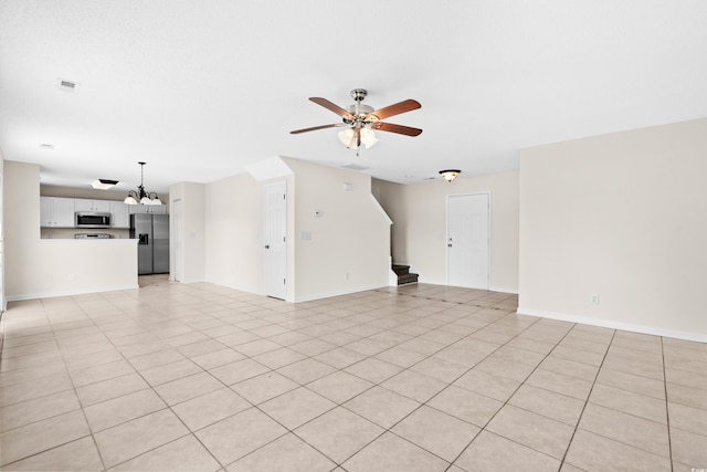 unfurnished living room featuring ceiling fan and light tile patterned floors