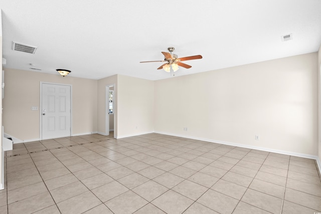 empty room with light tile patterned floors and ceiling fan