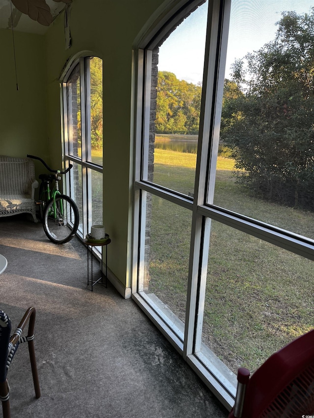 sunroom / solarium with a water view