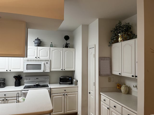 kitchen with white cabinets and white appliances