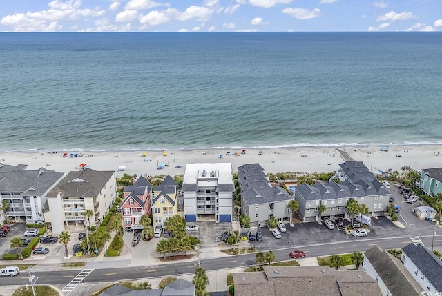 bird's eye view featuring a view of the beach and a water view