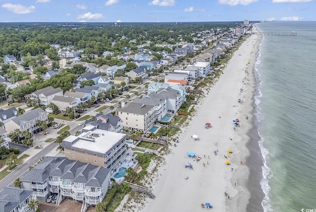 aerial view with a water view and a beach view