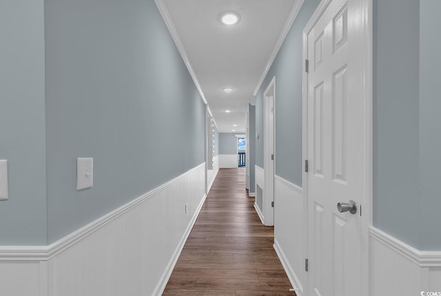 hallway with crown molding and dark hardwood / wood-style flooring