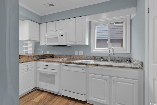 kitchen featuring white cabinets, white appliances, light hardwood / wood-style floors, and sink