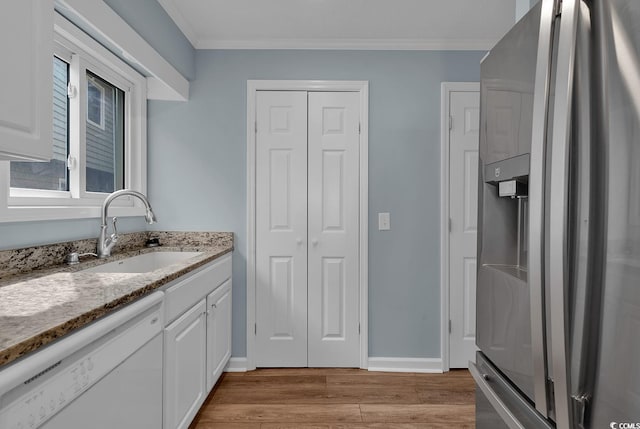 kitchen with white cabinetry, dishwasher, sink, light hardwood / wood-style flooring, and stainless steel fridge