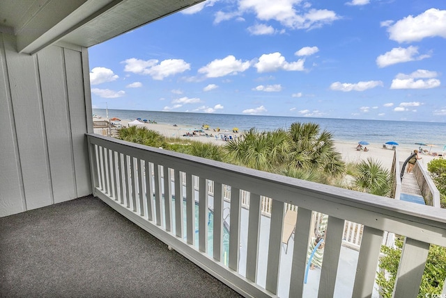 balcony with a view of the beach and a water view