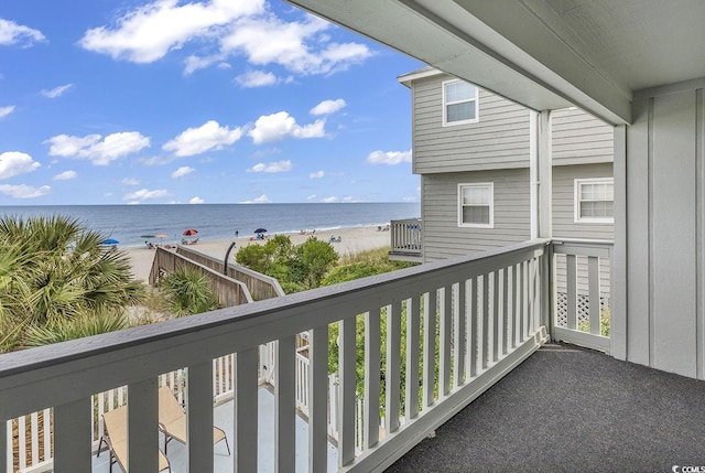 balcony featuring a water view and a view of the beach