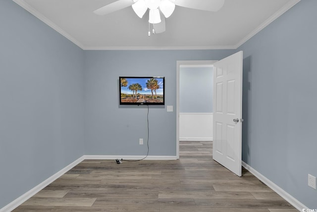 spare room featuring ceiling fan, ornamental molding, and light wood-type flooring