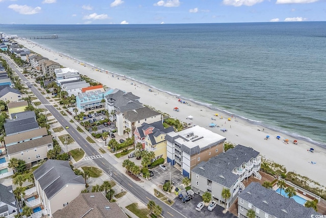 bird's eye view with a water view and a beach view