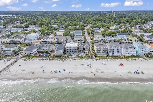 birds eye view of property with a water view and a view of the beach