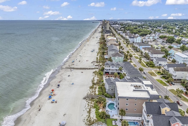 bird's eye view with a water view and a beach view