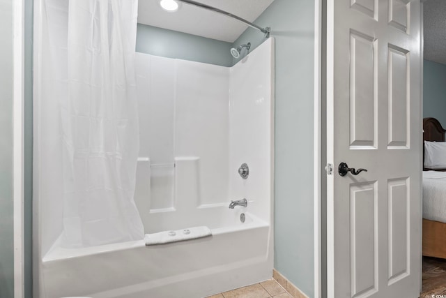 bathroom with tile patterned flooring and shower / bath combo with shower curtain