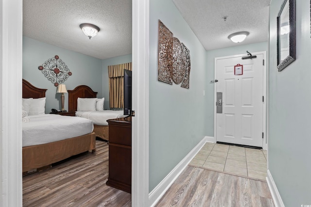 interior space featuring a textured ceiling and light hardwood / wood-style flooring