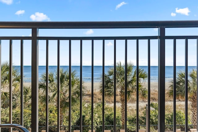 balcony with a water view and a beach view