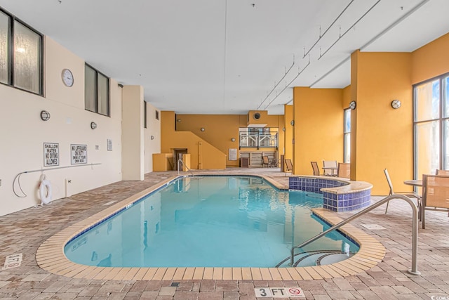 view of pool with pool water feature, a hot tub, and a patio