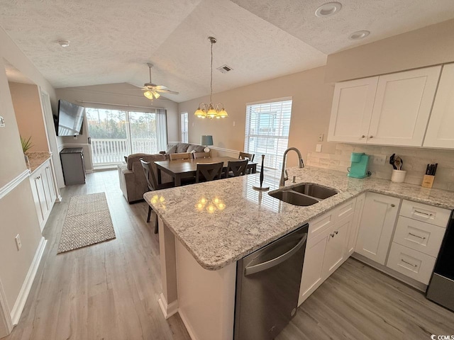 kitchen featuring dishwasher, lofted ceiling, sink, and kitchen peninsula