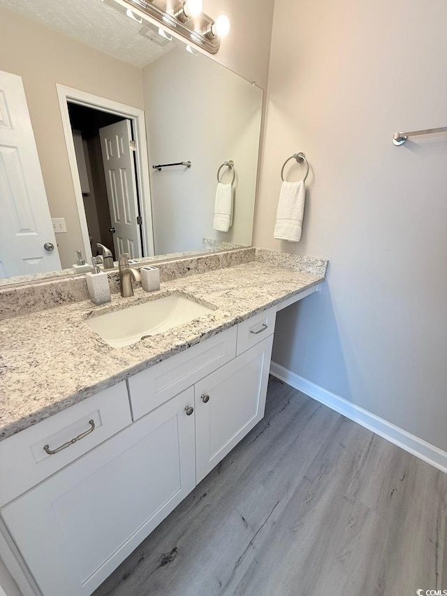 bathroom with vanity and hardwood / wood-style flooring