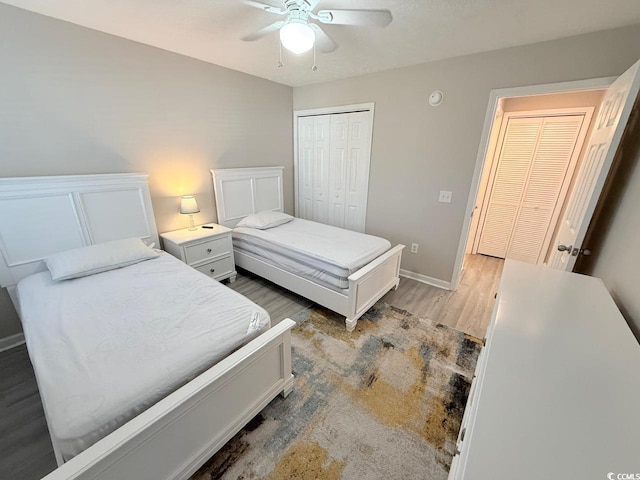 bedroom featuring wood-type flooring, ceiling fan, and a closet