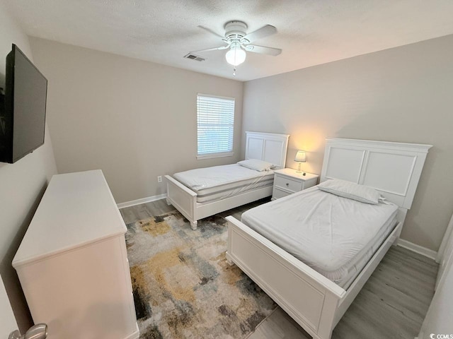 bedroom featuring light hardwood / wood-style flooring and ceiling fan