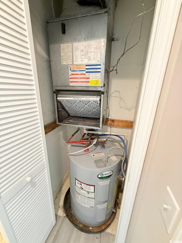 utility room with heating unit and water heater