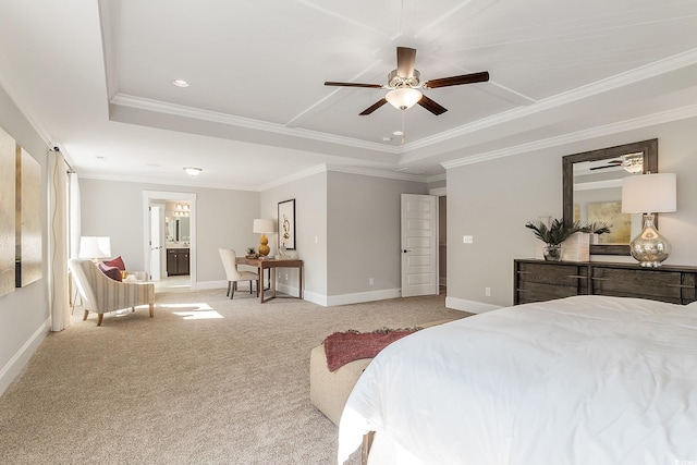 carpeted bedroom featuring a tray ceiling, ceiling fan, crown molding, and ensuite bathroom