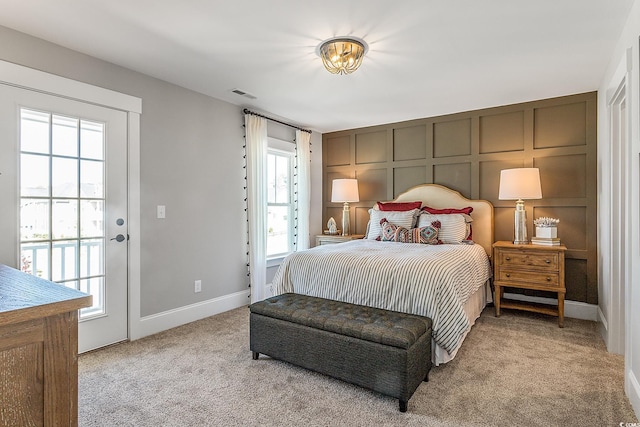 bedroom featuring light carpet and access to outside