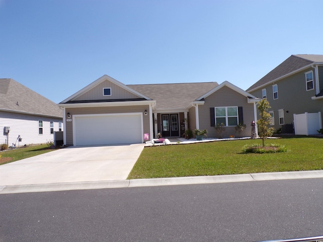 single story home with an attached garage, cooling unit, a front lawn, and concrete driveway