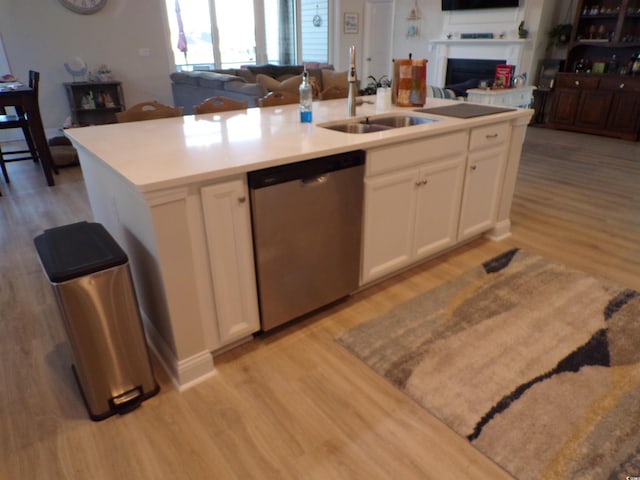 3070 Sutherland Dr, Little River, SC 29566 - kitchen featuring stainless steel dishwasher, a sink, open floor plan, and light wood finished floors