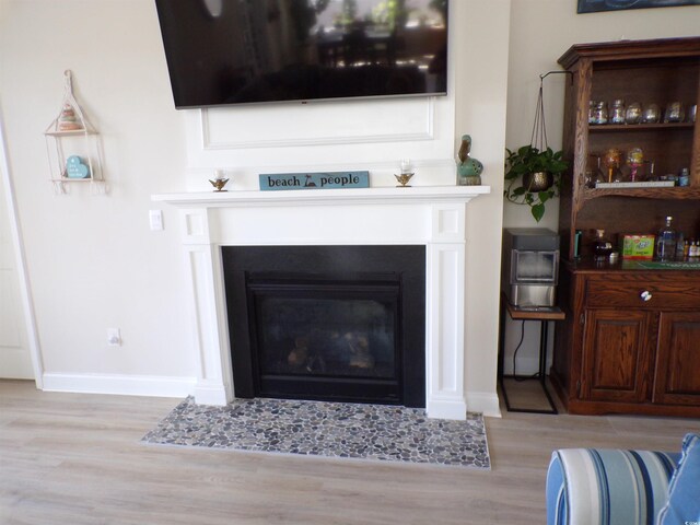 3070 Sutherland Dr, Little River, SC 29566 - detailed view of a fireplace with flush hearth, wood finished floors, and baseboards