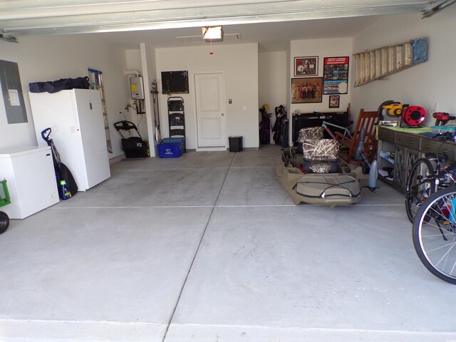 3070 Sutherland Dr, Little River, SC 29566 - garage with electric panel, a garage door opener, fridge, and water heater