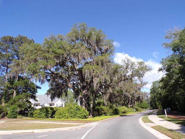 3070 Sutherland Dr, Little River, SC 29566 - view of asphalt road featuring curbs and sidewalks