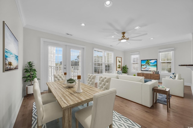 dining space with hardwood / wood-style floors, french doors, ceiling fan, and ornamental molding