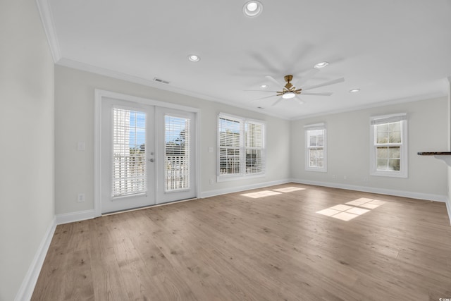 empty room featuring french doors, light hardwood / wood-style floors, ceiling fan, and crown molding