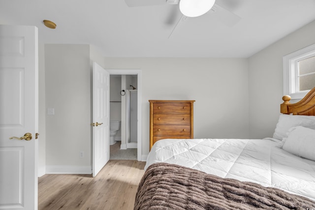 bedroom with light hardwood / wood-style floors, ensuite bath, and ceiling fan