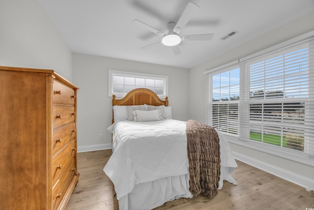 bedroom with ceiling fan and light hardwood / wood-style floors