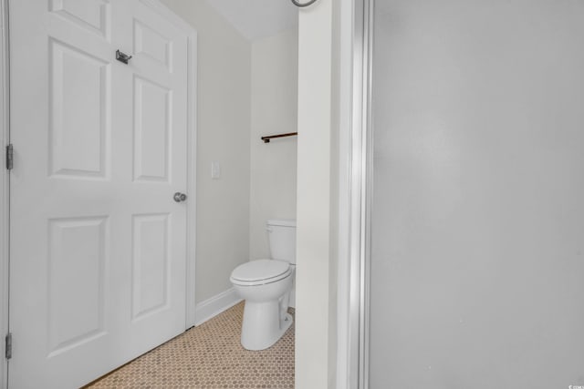 bathroom with tile patterned flooring and toilet